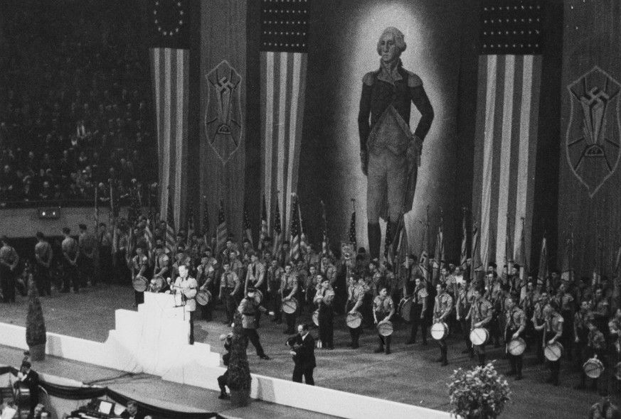 Drummers on stage, the backdrop featuring a large portrait of George Washington flanked by Swastikas and American flags, during a German American Bund rally at Madison Square Garden in Midtown Manhatt ...