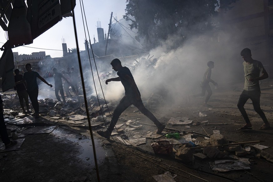 Palestinians look for survivors following an Israeli airstrike in Khan Younis refugee camp, southern Gaza Strip, Tuesday, Nov. 7, 2023. (AP Photo/Fatima Shbair)