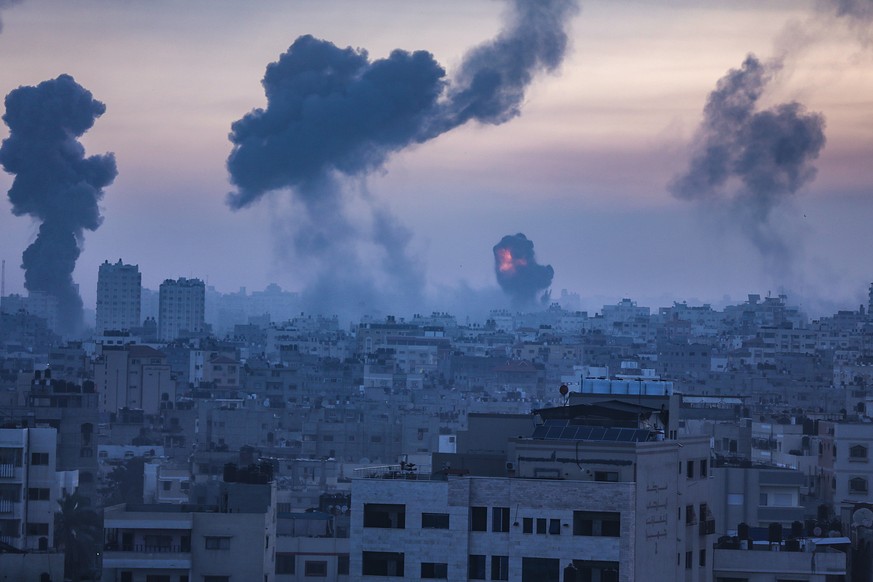 epa09192926 Smoke and flames rise after an Israeli airstrike on Gaza City, 12 May 2021. At least one woman was killed after 130 rockets, fired by Hamas from the Gaza strip, fell on Tel Aviv and neighb ...