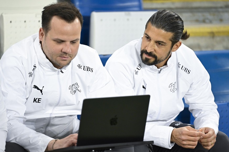 Switzerland assistant coach Davide Calla, right, and video analyst Kevin Ehmes look at a computer screen during an international test match between Northern Ireland and Switzerland, at Windsor Park st ...