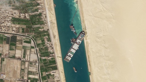 FILE - In this March 28, 2021, satellite file image from Planet Labs Inc, the cargo ship MV Ever Given sits stuck in the Suez Canal near Suez, Egypt. Consumers may face shortages and higher prices for ...