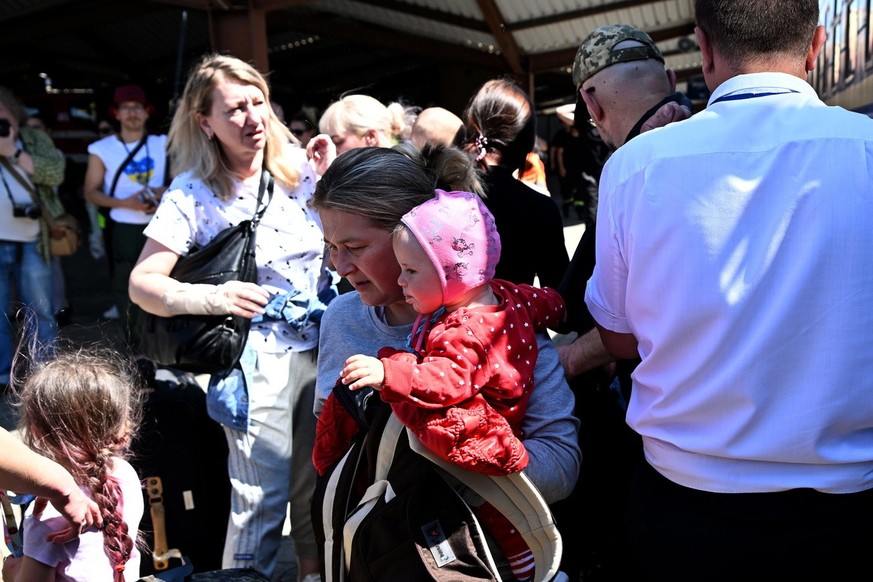 Ukrainian refugees of a passenger train from Odessa arrive at the train station in Przemysl, southeastern Poland, 12 May 2022.