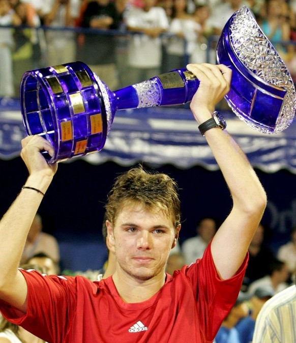 Swiss Stanislas Wawrinka lifts the trophy after the Croatian Open tennis final match against Serbian Novak Djokovic in Umag, Croatia, Sunday 30 July 2006. Djokovic retired from the match with breathin ...