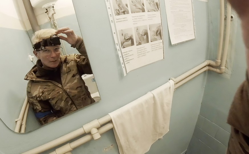 Yuliia Paievska, known as Taira, looks in the mirror and turns off her camera in Mariupol, Ukraine on Feb. 27, 2022. Using a body camera, she recorded her team&#039;s frantic efforts to bring people b ...