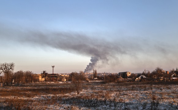 Smoke rises after shelling in Soledar, the site of heavy battles with Russian forces in the Donetsk region, Ukraine, Sunday, Jan. 8, 2023. (AP Photo/Roman Chop)