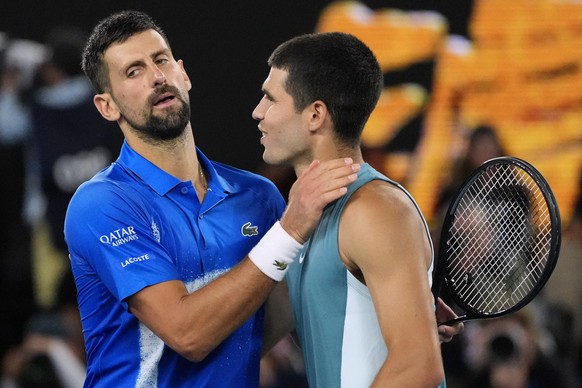 Novak Djokovic, left, of Serbia, is congratulated by Carlos Alcaraz of Spain following their quarterfinal match at the Australian Open tennis championship in Melbourne, Australia, Wednesday, Jan. 22,  ...
