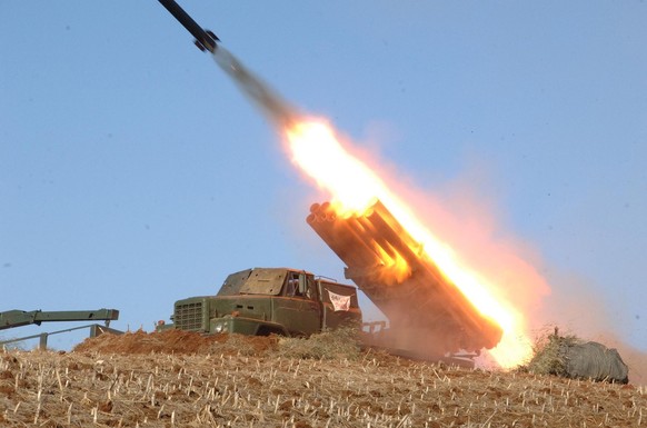 In this undated photo released by the Korean Central News Agency (KCNA) and distributed Thursday, March 14, 2013, by the Korea News Service, a rocket launcher is fired during a live drill by the Jangj ...