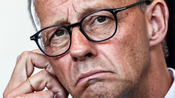 epa12297995 German Chancellor Friedrich Merz attends a press conference with Ukrainian President Volodymyr Zelensky (unseen) after a video call with other heads of state ahead of a summit between the  ...