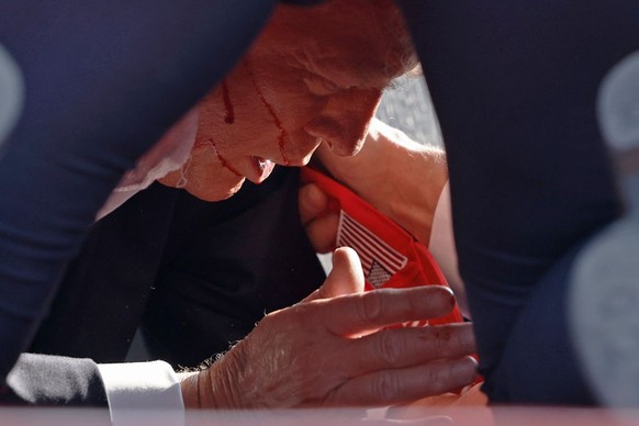 BUTLER, PENNSYLVANIA - JULY 13: Secret Service tend to republican presidential candidate former President Donald Trump onstage at a rally on July 13, 2024 in Butler, Pennsylvania. Butler County distri ...