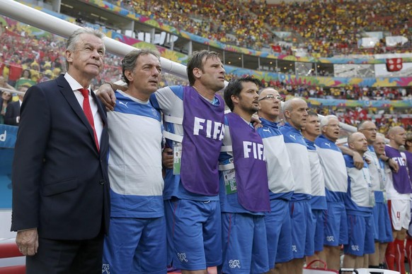 Michel Pont (deuxième depuis la gauche) à côté de l'ancien sélectionneur de la Nati Ottmar Hitzfeld (en costard-cravate) lors d'un match de la Coupe du monde 2014.