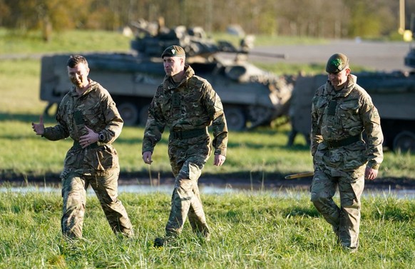 SALISBURY, ENGLAND - NOVEMBER 23: Prince William, Prince of Wales, Colonel-in-Chief, 1st Battalion Mercian Regiment (L) listens to a briefing ahead of an attack exercise during a visit to the regiment ...