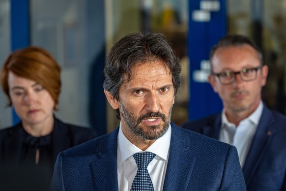 epa11347807 Slovak Defence Minister and Deputy Prime Minister Robert Kalinak (C), flanked by director of the F. D. Roosevelt University Hospital Miriam Lapunikova (L), addresses the media outside the  ...