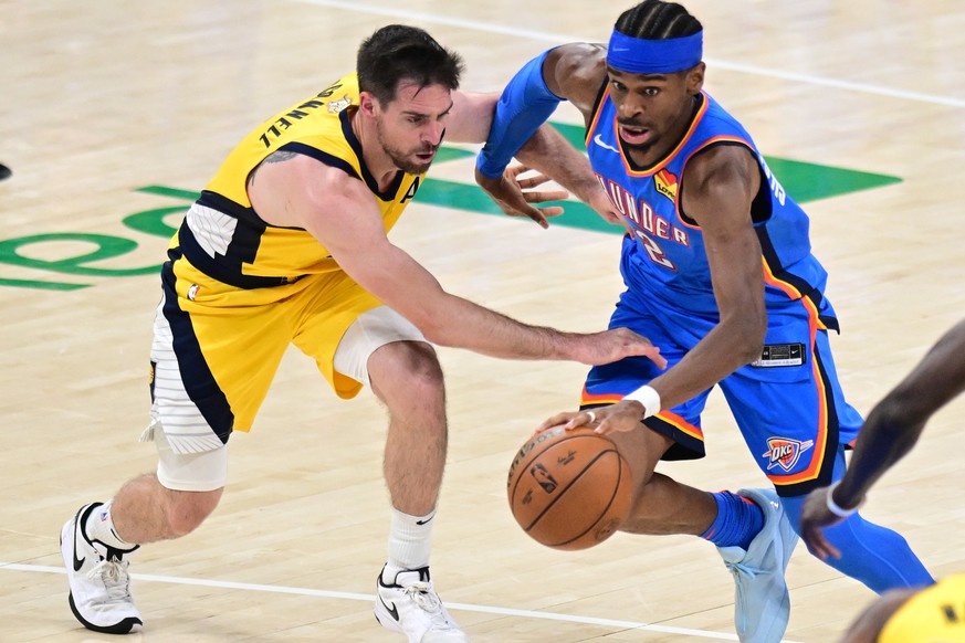 epa12192009 Oklahoma City Thunder guard Shai Gilgeous-Alexander (R) drives to the basket past Indiana Pacers guard T.J. McConnell (L) during the second half of game seven of the NBA finals between the ...