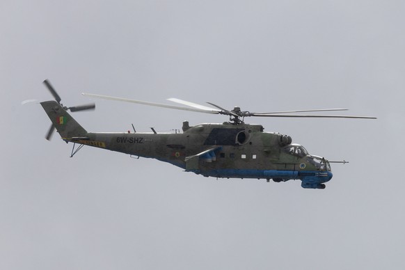 epa11454608 A Mil Mi-24 attack helicopter of the Senegalese Air Force flies by during the patronal celebration of the Air Force in Dakar, Senegal, 03 July 2024. The Senegalese Air Force was formed in  ...