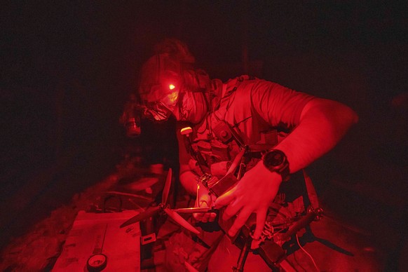A Ukrainian soldier of 3rd assault brigade prepares FPV exploding drone before flight over Russian positions in Kharkiv region, Ukraine, on Sunday, Aug. 25, 2024. (AP Photo/Evgeniy Maloletka)