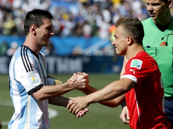 Argentina's Lionel Messi shakes hands with Switzerland's Xherdan Shaqiri before the World Cup round of 16 soccer match between Argentina and Switzerland at the Itaquerao Stadium in Sao Paulo ...
