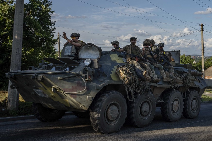 Ukrainian soldiers ride a tank, on a road in Donetsk region, eastern Ukraine, Wednesday, July 20, 2022. Russian Foreign Minister Sergey Lavrov told state-controlled RT television and the RIA Novosti n ...