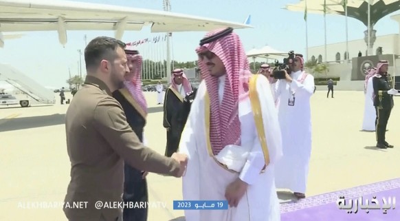 This video grab shows Ukrainian President Volodymyr Zelenskyy, left, arriving at the airport in Jeddah, Saudi Arabia, Friday May 19, 2023. Zelenskyy announced Friday he has kicked off a visit to Saudi ...