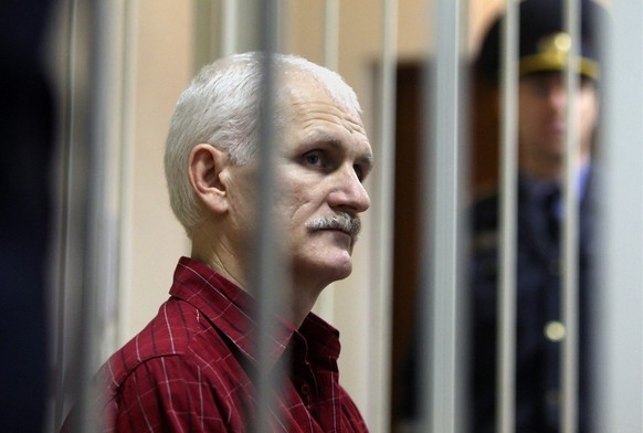 epa02988901 A Belarussian human rights activist Ales Belyatsky is seen in a cage in a court room prior to a court session in Minsk, Belarus, 02 November 2011.Ales Bialiatski is a leader of Viasna, a h ...