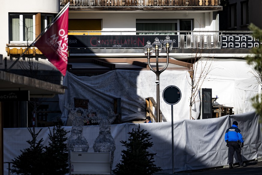 epa12620591 Police officers inspect the area where a fire broke out at the Le Constellation bar and lounge following an explosion in the early hours of New Year's Eve, in Crans-Montana, Switzerla ...