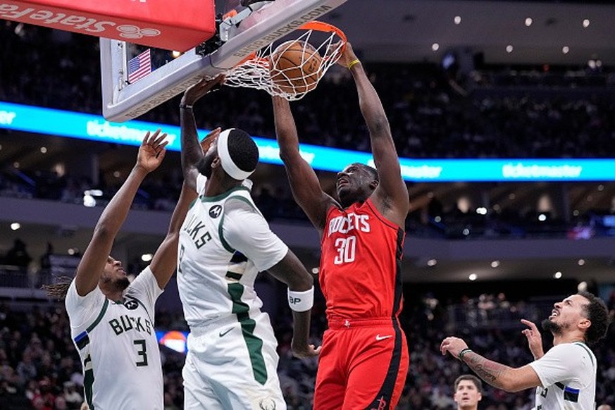 MILWAUKEE, WISCONSIN - NOVEMBER 09: Clint Capela #30 of the Houston Rockets scores on a dunk over Bobby Portis #9 and Meyers Leonard #3 of the Milwaukee Bucks during the first half of the game at Fise ...