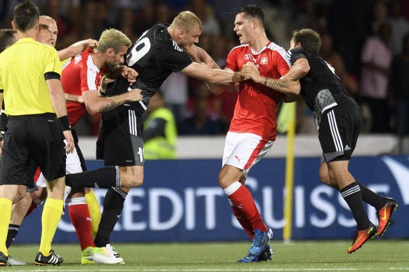 Swiss midfielder Valon Behrami, left, and Swiss midfielder Granit Xhaka, second from right, fight with Belarus&#039; Dzianis Laptseu, second from left, and Belarus&#039; Pavel Savitski, right, during  ...