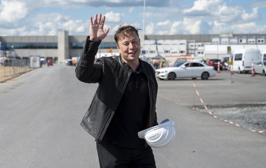 Elon Musk, Tesla CEO, stands on the construction site of the Tesla factory and waves in Gruenheide near Berlin, Monday, May 17, 2021. He has taken a look at the progress of construction of the new fac ...
