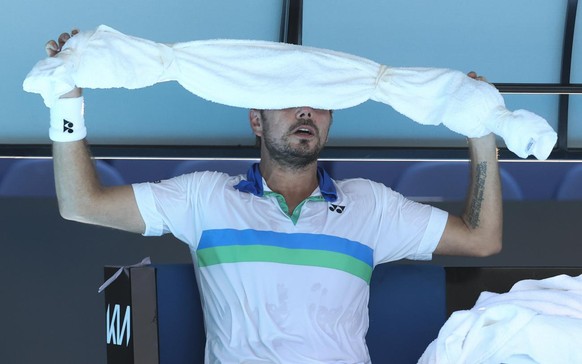 Switzerland&#039;s Stan Wawrinka holds an ice towel to his head during his second round match against Hungary&#039;s Marton Fucsovics at the Australian Open tennis championship in Melbourne, Australia ...