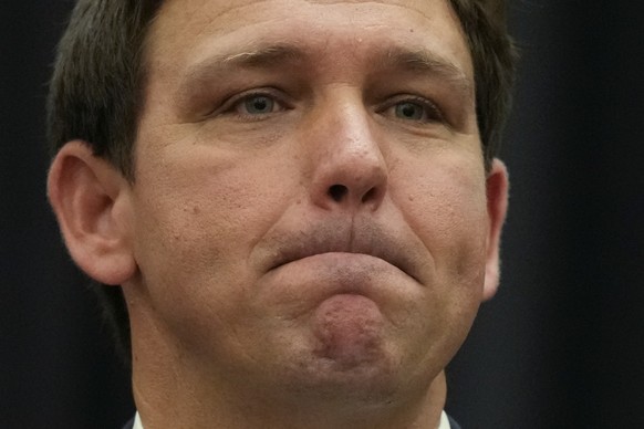 Florida Gov. Ron DeSantis listens during a news conference Thursday, Sept. 22, 2022, in Miami. (AP Photo/Rebecca Blackwell)