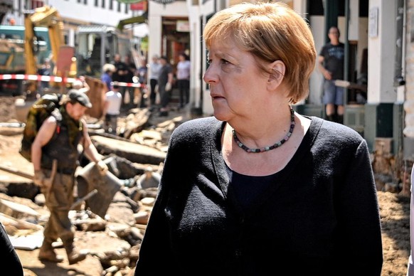 epa09354962 German Chancellor Angela Merkel inspect the damage after heavy flooding of the river Erft caused severe destruction in the village of Bad Muenstereifel, Euskirchen district, Germany, 20 Ju ...