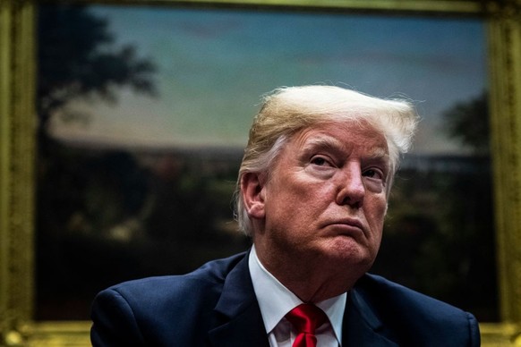 WASHINGTON, DC - DECEMBER 18 : President Donald J. Trump listens at a roundtable with family members of victims, state and local officials, and Cabinet members to discuss recommendations in the Federa ...
