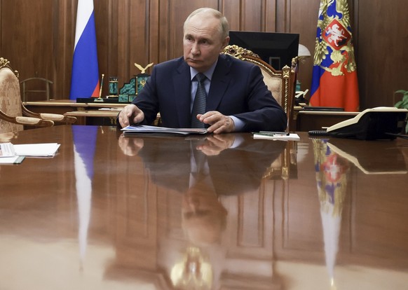 Russian President Vladimir Putin speaks with Promsvyazbank Chairman and CEO Pyotr Fradkov at the Kremlin in Moscow, Russia, Thursday, Aug. 29, 2024. (Alexander Kazakov, Sputnik, Kremlin, Pool Photo vi ...
