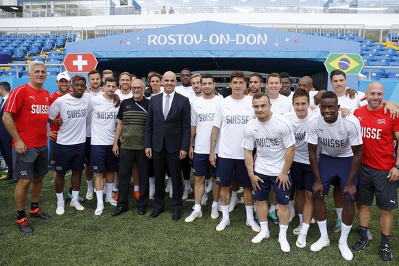 Swiss Federal President Alain Berset, center, poses with the Swiss national soccer team players prior to a training session on the eve of the group E match between Switzerland and Brazil of the FIFA s ...