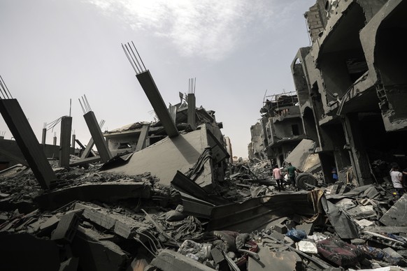 epa11332560 Palestinians inspect the rubble of their destroyed houses following an Israeli air strike in Al Maghazi refugee camp, southern Gaza Strip, 11 May 2024. More than 34,900 Palestinians and ov ...