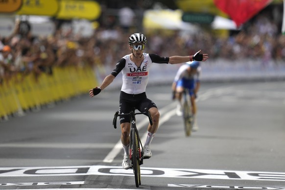 Britain&#039;s Adam Yates celebrates after crossing the finish line of the first stage of the Tour de France cycling race over 182 kilometers (113 miles) with start and finish in Bilbao, Spain, Saturd ...