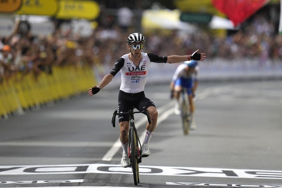 Britain's Adam Yates celebrates after crossing the finish line of the first stage of the Tour de France cycling race over 182 kilometers (113 miles) with start and finish in Bilbao, Spain, Saturd ...