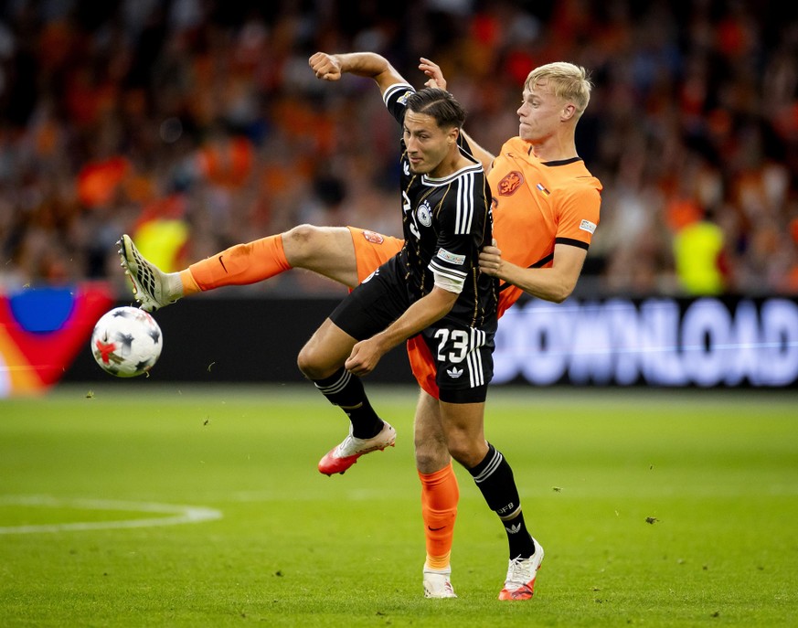 epa13261466 Younes Ebnoutalib (front) of Germany and Jan Paul van Hecke of the Netherlands during the UEFA Nations League match between the Netherlands and Germany at the Johan Cruijff ArenA, in Amste ...