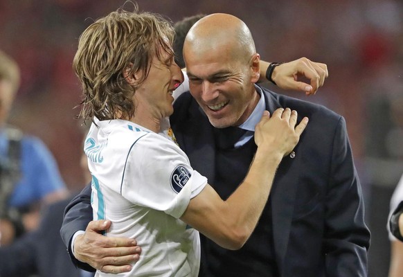 Real Madrid coach Zinedine Zidane, right, celebrates with Luka Modric after winning the Champions League Final soccer match between Real Madrid and Liverpool at the Olimpiyskiy Stadium in Kiev, Ukrain ...