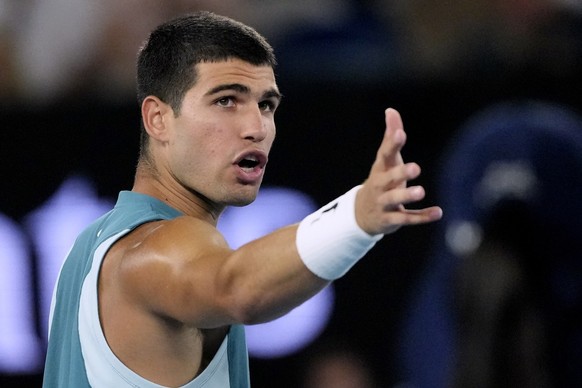 Carlos Alcaraz of Spain gestures as he speaks to the chair umpire during his quarterfinal match against Novak Djokovic of Serbia at the Australian Open tennis championship in Melbourne, Australia, Tue ...