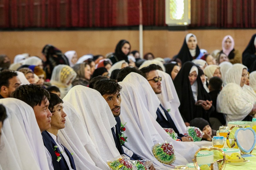 epa12732076 Afghan grooms gather during a mass wedding ceremony organised by a charity in Kabul, Afghanistan, 12 February 2026. The charity hosted a mass wedding for 90 couples to ease financial burde ...