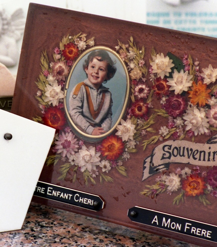 A photo sits on the grave of Gr�gory Villemin in a village cemetery in Lepanges-sur-Vologne, south-west France in 1987. Gr�gory Villemin was found dead in the Vologne River in Eastern France on Oct. 1 ...