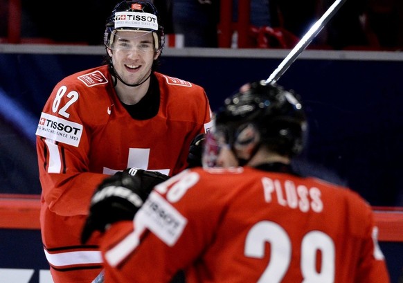 Switzerland&amp;#039;s Simon Moser, top, reacts after the 5-1 goal against Slovenia during the Ice Hockey World Championship group A match in Stockholm, Sweden, Tuesday May 8, 2013. (AP Photo/Anders W ...