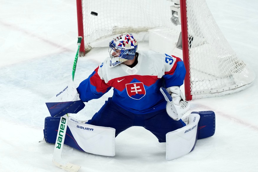 Slovakia goalkeeper Samuel Hlavaj reaches for a shot by Finland's Kaapo Kakko that gets past him for a goal during the third period of the men's ice hockey bronze medal game at the 2026 Wint ...