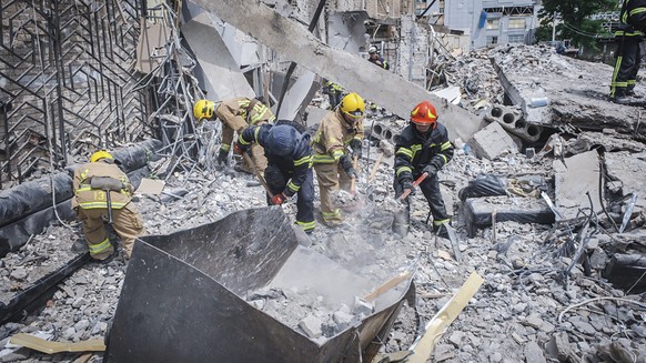 epa10715615 A handout photo made available by the State Emergency Service of Ukraine shows rescuers at work at the site of a rocket strike in downtown Kramatorsk, Donetsk area, Ukraine, 28 June 2023,  ...