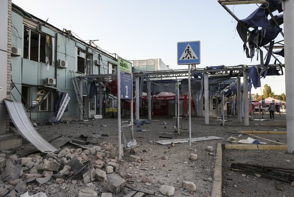 epa12292775 Ukrainian rescuers and policemen work at the site of the Russian strike on a bus station in Zaporizhzhia, Ukraine, 10 August 2025. At least 19 people were injured after a Russian guided ae ...