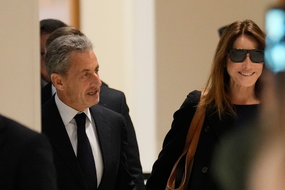 Former French President Nicolas Sarkozy and his wife Carla Bruni Sarkozy arrive to the courtroom for his verdict for alleged illegal financing of his 2007 presidential campaign by the government of th ...