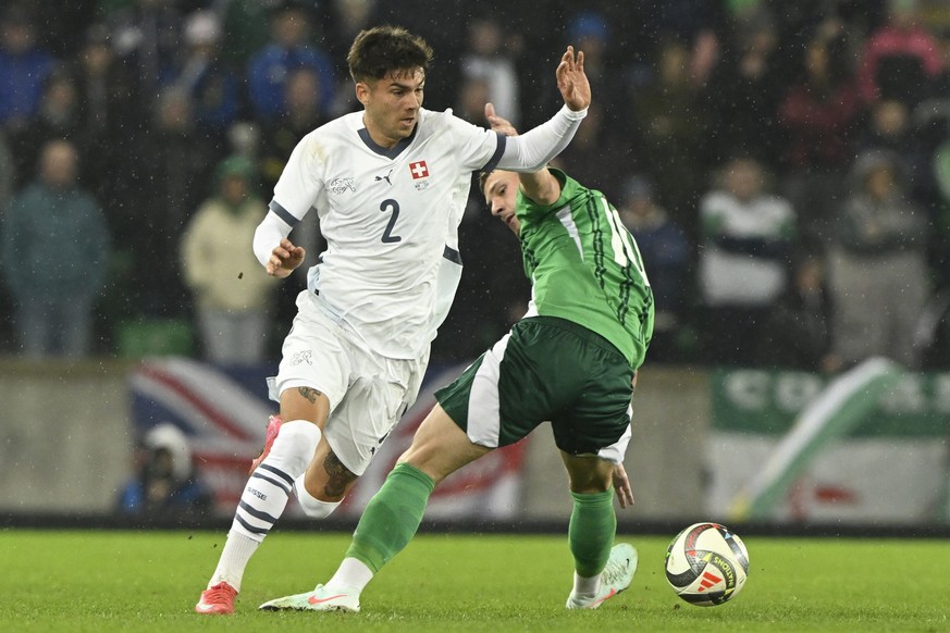 Switzerland&#039;s Lucas Blondel, left, and Northern Ireland&#039;s Jamie Donley in action during an international test match between Northern Ireland and Switzerland, at Windsor Park stadium in Belfa ...