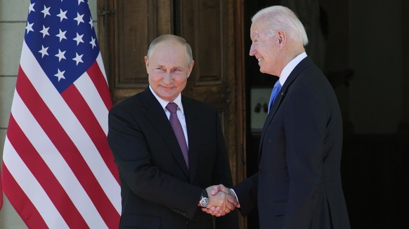 FILE - Russian President Vladimir Putin, left, and U.S President Joe Biden shake hands during their meeting at the &#039;Villa la Grange&#039; in Geneva, Switzerland in Geneva, Switzerland, on June 16 ...