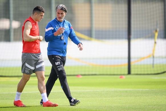 Switzerland&#039;s head coach Murat Yakin, right, speaks with Switzerland&#039;s midfielder Granit Xhaka, left, during a closed training session of Swiss national soccer team in preparation for the FI ...
