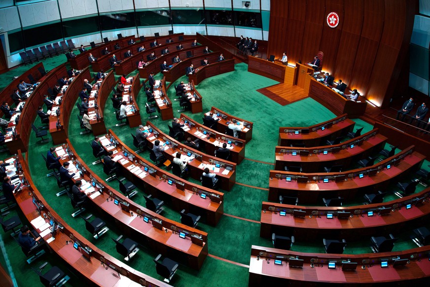 FILE - In this Wednesday, March 17, 2021, file photo, Hong Kong Chief Executive Carrie Lam listens to questions during a question and answer session at the Legislative Council in Hong Kong. China&#039 ...